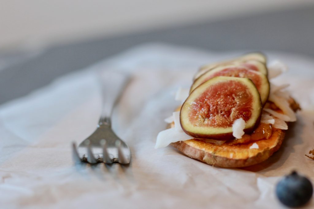 Sweet potato toast with almond butter, coconut flakes, and fresh figs